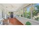 Bright sunroom with wood floors, white trim, and natural light, a perfect space to relax and enjoy the view at 1742 9Th St, Sarasota, FL 34236