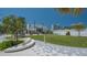 An attractive urban green space has seating, hexagonal blue and white patterned pavement and green space at 1742 9Th St, Sarasota, FL 34236