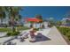 Inviting public square features a bright orange sunshade and outdoor seating at 1742 9Th St, Sarasota, FL 34236