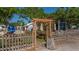 Outdoor dining area, partially enclosed by a wooden fence, features a picnic table and blooming bougainvillea at 1742 9Th St, Sarasota, FL 34236