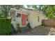 This charming home boasts a colorful front door, mature plants, and gravel landscaping at 1742 9Th St, Sarasota, FL 34236