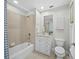 Clean bathroom with a combined tub and shower, vanity, and neutral tile flooring at 1771 Ringling Blvd # 1104, Sarasota, FL 34236