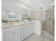 Bathroom featuring double sinks with shower behind them and a glass shower enclosure at 1771 Ringling Blvd # 1104, Sarasota, FL 34236