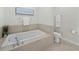 Bathroom featuring a soaking tub and adjacent toilet at 1771 Ringling Blvd # 1104, Sarasota, FL 34236