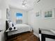 Bright bedroom with hardwood floors, white walls, and a large window with city views at 1771 Ringling Blvd # 1104, Sarasota, FL 34236