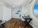 Well-appointed bedroom with a built-in Murphy bed, desk, and striking round window at 1771 Ringling Blvd # 1104, Sarasota, FL 34236