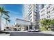 Luxurious building entrance with well manicured tropical landscaping and a covered entryway at 1771 Ringling Blvd # 1104, Sarasota, FL 34236