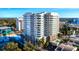 Stunning exterior view of a modern high-rise condominium with balconies and a swimming pool at 1771 Ringling Blvd # 1104, Sarasota, FL 34236