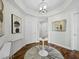 Elegant condo foyer with hardwood floors, decorative lighting, and sophisticated wall art at 1771 Ringling Blvd # 1104, Sarasota, FL 34236