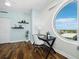 Bright home office with unique round window, modern desk, and stylish decor at 1771 Ringling Blvd # 1104, Sarasota, FL 34236