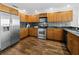 Well-lit kitchen with stainless steel appliances, wood cabinets, and modern backsplash at 1771 Ringling Blvd # 1104, Sarasota, FL 34236