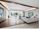 Open concept living room featuring two toned hardwood floors, modern furnishings, and a tv at 1771 Ringling Blvd # 1104, Sarasota, FL 34236