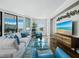 Modern living room with hardwood floors, upscale furniture, and a large flat-screen television at 1771 Ringling Blvd # 1104, Sarasota, FL 34236