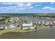 Aerial view of a Primary-planned community with lake, clubhouse, tennis courts, playground, and lawn bowling at 18045 Polo Trail St, Bradenton, FL 34211
