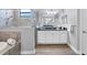Bathroom showcasing a soaking tub, glass enclosed shower, double vanity and white cabinets at 18045 Polo Trail St, Bradenton, FL 34211