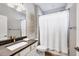Bathroom featuring shower with a curtain, toilet, vanity with dark counter, and decorative wall art at 18045 Polo Trail St, Bradenton, FL 34211