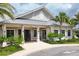 Attractive clubhouse exterior with metal roof, inviting entrance, and lush landscaping, including palm trees at 18045 Polo Trail St, Bradenton, FL 34211
