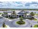 Exterior of the community center with palm trees, landscaping, and roundabout at 18045 Polo Trail St, Bradenton, FL 34211