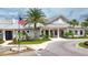 Attractive community center entrance with flagpole, landscaping, and well-maintained grounds at 18045 Polo Trail St, Bradenton, FL 34211
