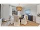 Inviting dining room with natural light, round table, and stylish chandelier at 18045 Polo Trail St, Bradenton, FL 34211