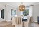 Well-lit dining room with round table, seating for six, and view to the outdoors at 18045 Polo Trail St, Bradenton, FL 34211