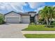 Beautiful single-Gathering home with a well-manicured lawn, stone accents, and a three-car garage at 18045 Polo Trail St, Bradenton, FL 34211
