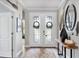 Inviting foyer with stylish double doors, decorative rug, and modern decor at 18045 Polo Trail St, Bradenton, FL 34211