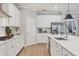 Spacious kitchen with stainless steel appliances, white cabinets, and island sink at 18045 Polo Trail St, Bradenton, FL 34211