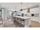 Well-lit kitchen featuring a large island with seating and views of dining area at 18045 Polo Trail St, Bradenton, FL 34211