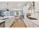 Bright kitchen with white cabinets, stainless steel appliances, and island sink at 18045 Polo Trail St, Bradenton, FL 34211