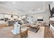 Open living room with kitchen, island with seating, and fireplace at 18045 Polo Trail St, Bradenton, FL 34211