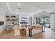 Bright living room featuring built-in shelving, a modern fireplace, and seamless indoor-outdoor flow at 18045 Polo Trail St, Bradenton, FL 34211