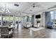 Bright and inviting lounge area with comfortable seating, fireplace, and large windows overlooking the outdoor amenities at 18045 Polo Trail St, Bradenton, FL 34211