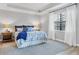 Comfortable primary bedroom with large window and calm decor at 18045 Polo Trail St, Bradenton, FL 34211