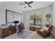 Office featuring a large window, wood desk and cabinets, leather chair, and a decorative map at 18045 Polo Trail St, Bradenton, FL 34211