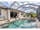 Beautiful pool and hot tub with screened enclosure and ample seating for enjoying the backyard at 18045 Polo Trail St, Bradenton, FL 34211