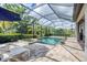 Sparkling pool and spa with screened enclosure, offering a private oasis at 18045 Polo Trail St, Bradenton, FL 34211