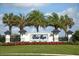Polo Run community entrance sign with lush landscaping and palm trees under a bright sky at 18045 Polo Trail St, Bradenton, FL 34211