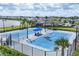 Community tennis courts feature well-maintained blue surface and shade shelter, perfect for recreational play at 18045 Polo Trail St, Bradenton, FL 34211