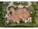 Aerial view of house with pool, stone patio, and lake at 19208 Ganton Ave, Lakewood Ranch, FL 34202