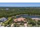 Expansive property featuring a grand home with a terracotta roof, lush greenery, and a large pond at 19208 Ganton Ave, Lakewood Ranch, FL 34202