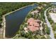 Back aerial view showing the terracotta roof, swimming pool, and nearby lake at 19208 Ganton Ave, Lakewood Ranch, FL 34202