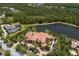 Back aerial view showing the terracotta roof, swimming pool, and nearby lake at 19208 Ganton Ave, Lakewood Ranch, FL 34202