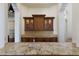 Elegant bar area featuring granite countertops, custom cabinetry, and designer finishes at 19208 Ganton Ave, Lakewood Ranch, FL 34202