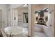 Travertine bathroom with a large soaking tub, a glass shower, and view of an outdoor fountain at 19208 Ganton Ave, Lakewood Ranch, FL 34202
