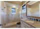 Beautiful bathroom with a walk-in shower, a stone vanity, and natural light from the window at 19208 Ganton Ave, Lakewood Ranch, FL 34202