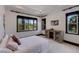 Bright bedroom featuring a decorative dresser and multiple windows at 19208 Ganton Ave, Lakewood Ranch, FL 34202