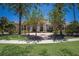 Stately home featuring lush landscaping, mature trees, and a circular brick driveway at 19208 Ganton Ave, Lakewood Ranch, FL 34202