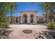 Elegant home with a grand entrance, arched doorways, and manicured landscaping at 19208 Ganton Ave, Lakewood Ranch, FL 34202