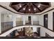 Luxury home foyer featuring a dark wood ceiling, a hanging light fixture, and wrought iron railings at 19208 Ganton Ave, Lakewood Ranch, FL 34202